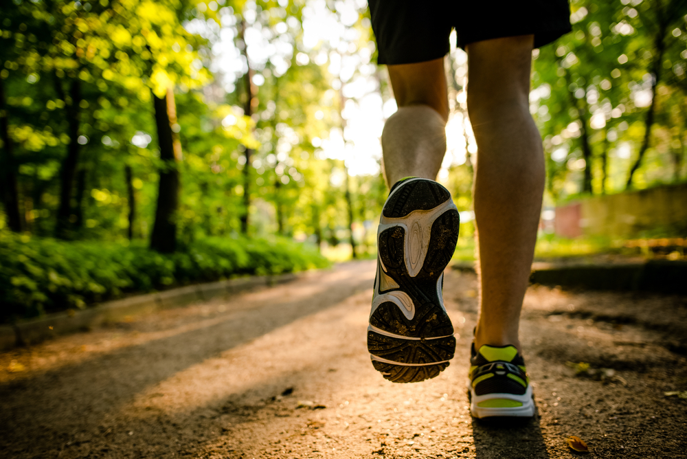 runner running through woods
