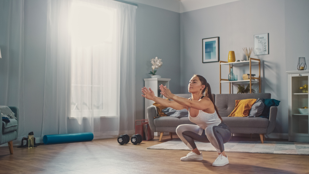 woman doing a squat for a home workout